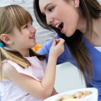 Girl and Woman in Responsive Feeding Session